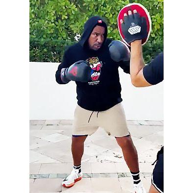 Navy Charly Bryan Puerto Rico heart hoodie worn during an outdoor boxing session.