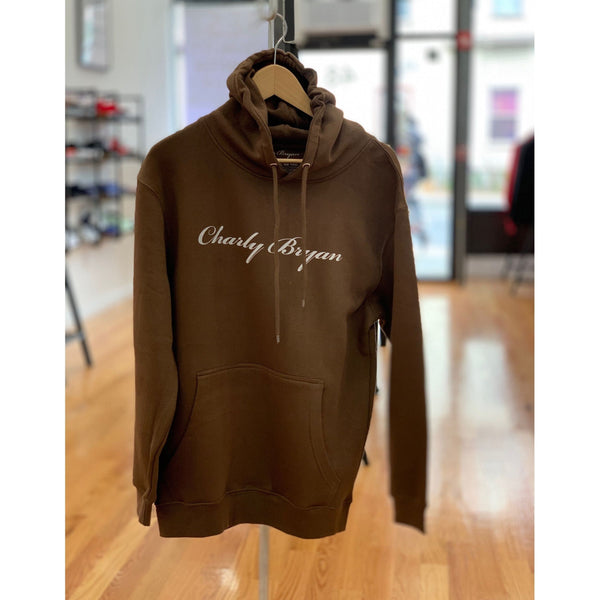 Chocolate-brown Charly Bryan Big Classic Logo hoodie hanging in a store, front view.